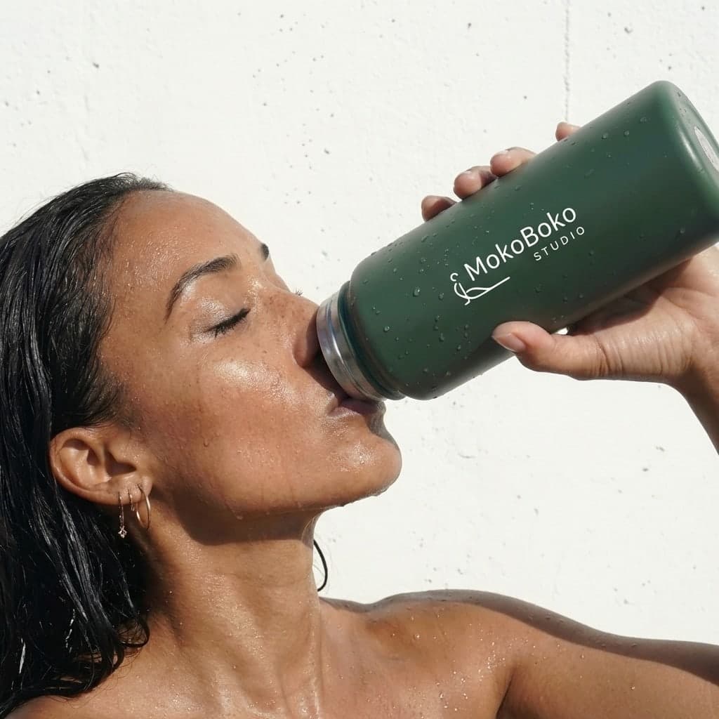 Woman with premium MokoBoko Studio forest green reusable metal water bottle—boutique pilates gear Lisbon
